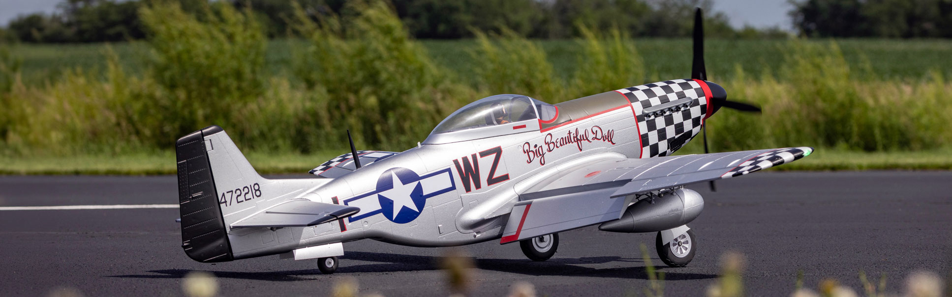 Action shot of the E-flite P-51D Mustang "Big Beautiful Doll" 1.5m on a tarmac 