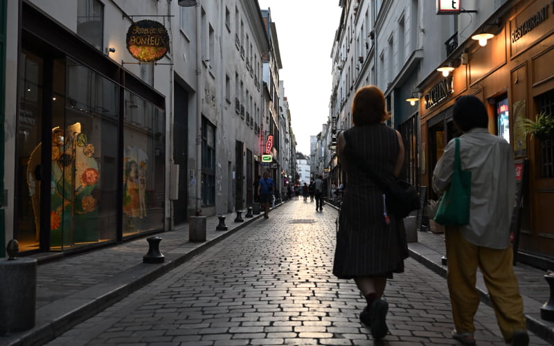 Photo of a couple walking down a low lit street taken with the NIKKOR Z 24-70mm f/2.8 S II
