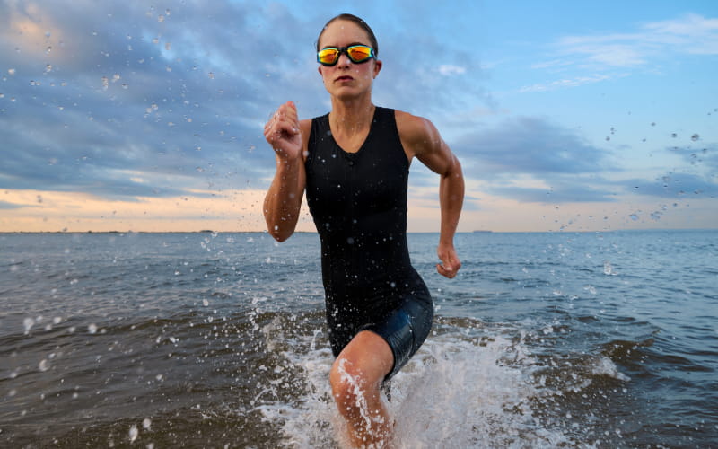 Photo of an athlete running on the beach taken with the NIKKOR Z 24-70mm f/2.8 S II lens