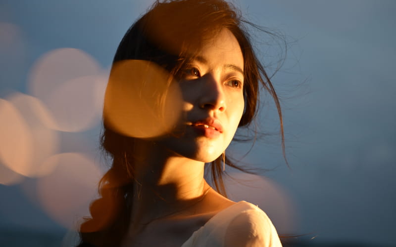 Beautiful bokeh of the NIKKOR Z 24-70mm f/2.8 S II lens shown in a portrait of a young woman