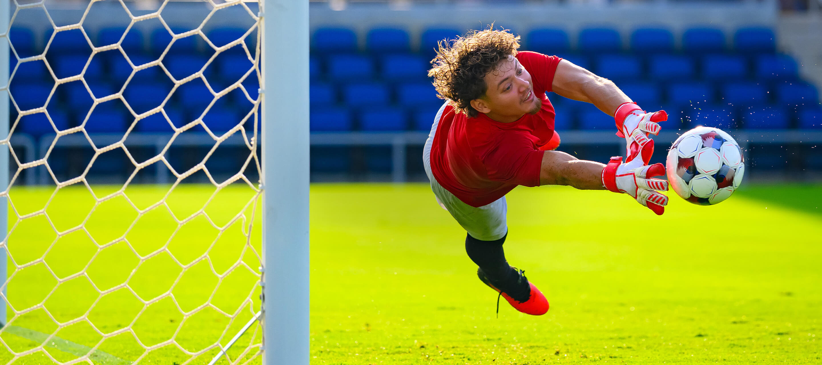 soccer goalie catching a ball