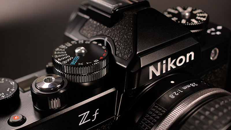 Close up photo of the top and front of the Z f with the NIKKOR Z 40mm f/2 (SE) lens attached as a thumbnail for a video
