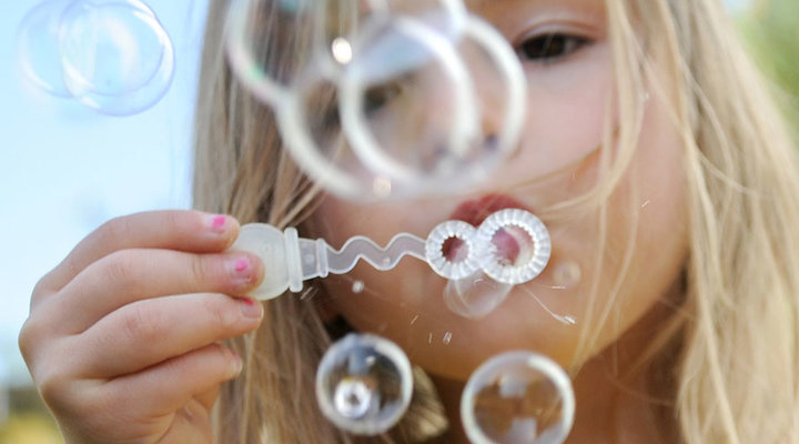 Jamie-Horton-kids-at-play-girl-blowing-bubbles.low.jpg
