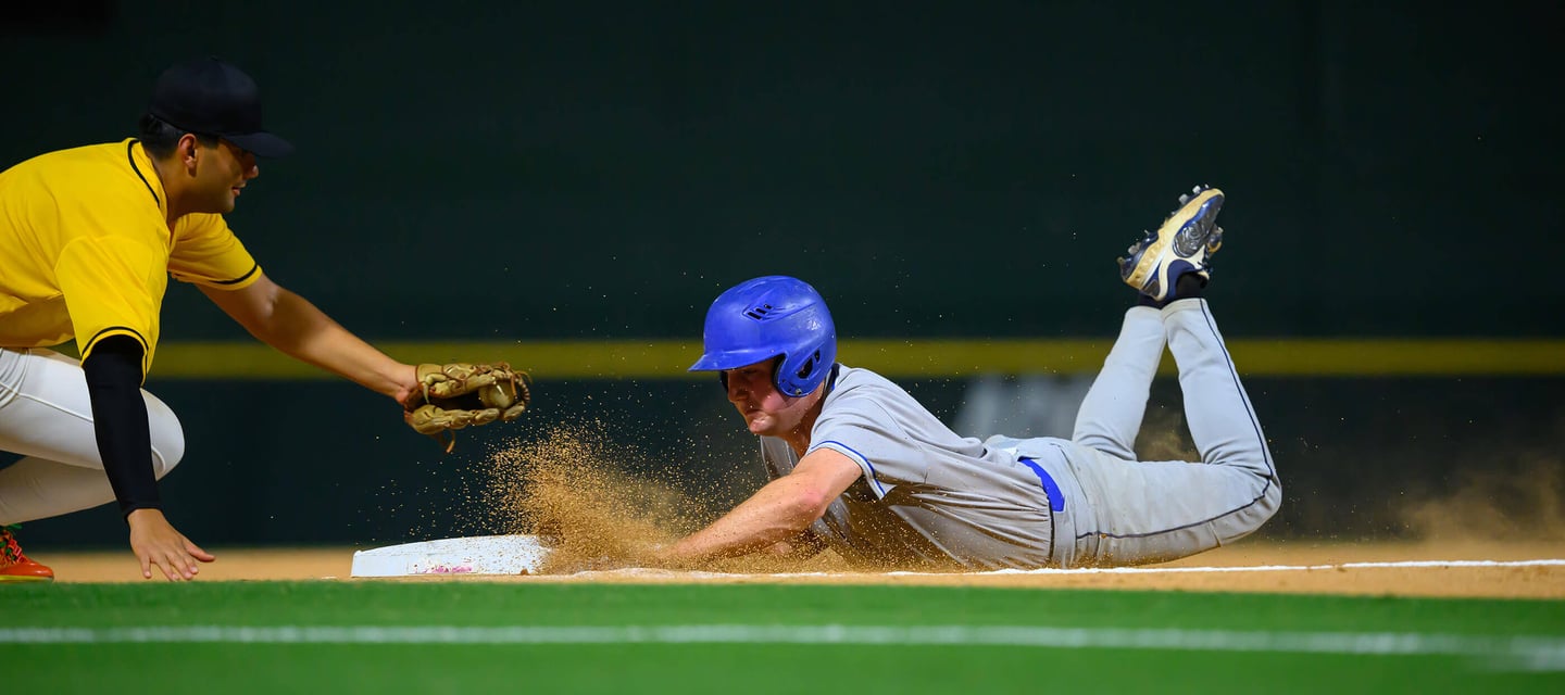 baseball player sliding to base