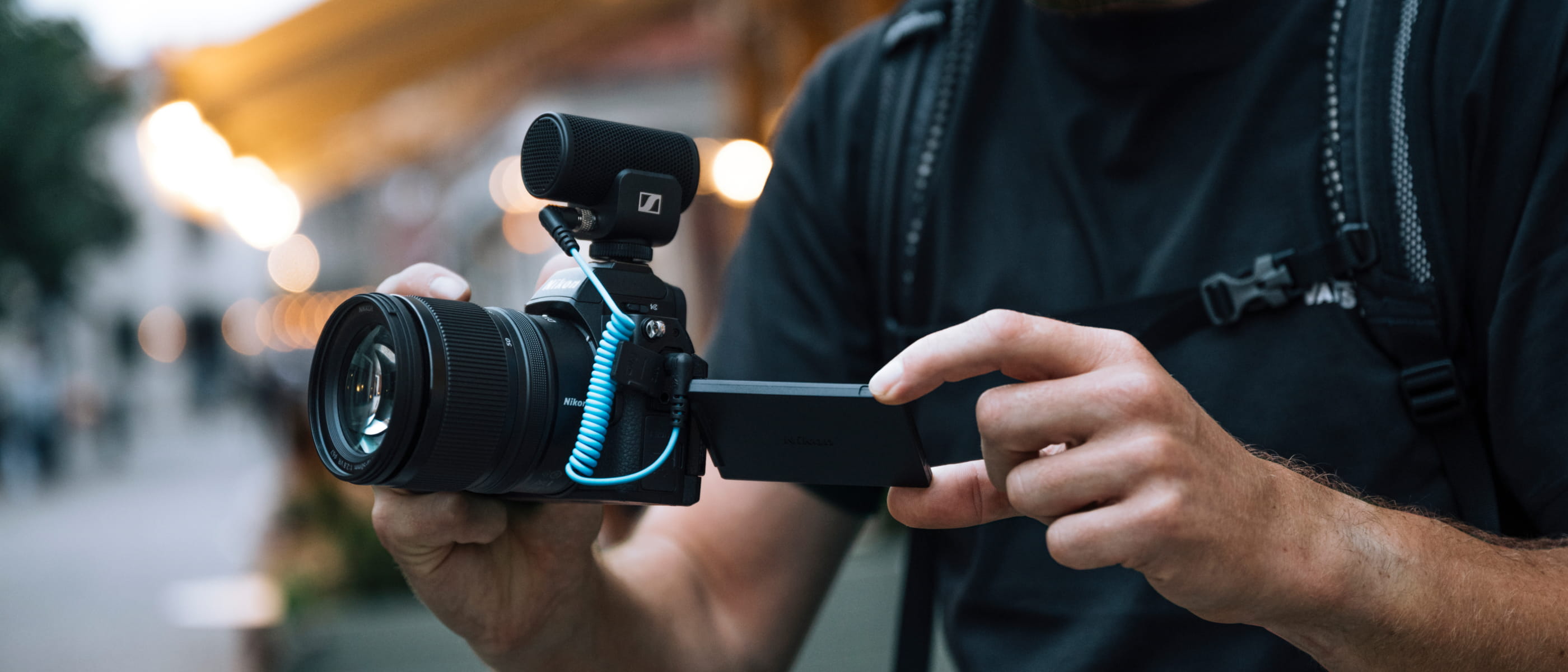 photo of a person shooting video with the NIKKOR Z DX 16-50mm f/2.8 VR lens on a Nikon camera