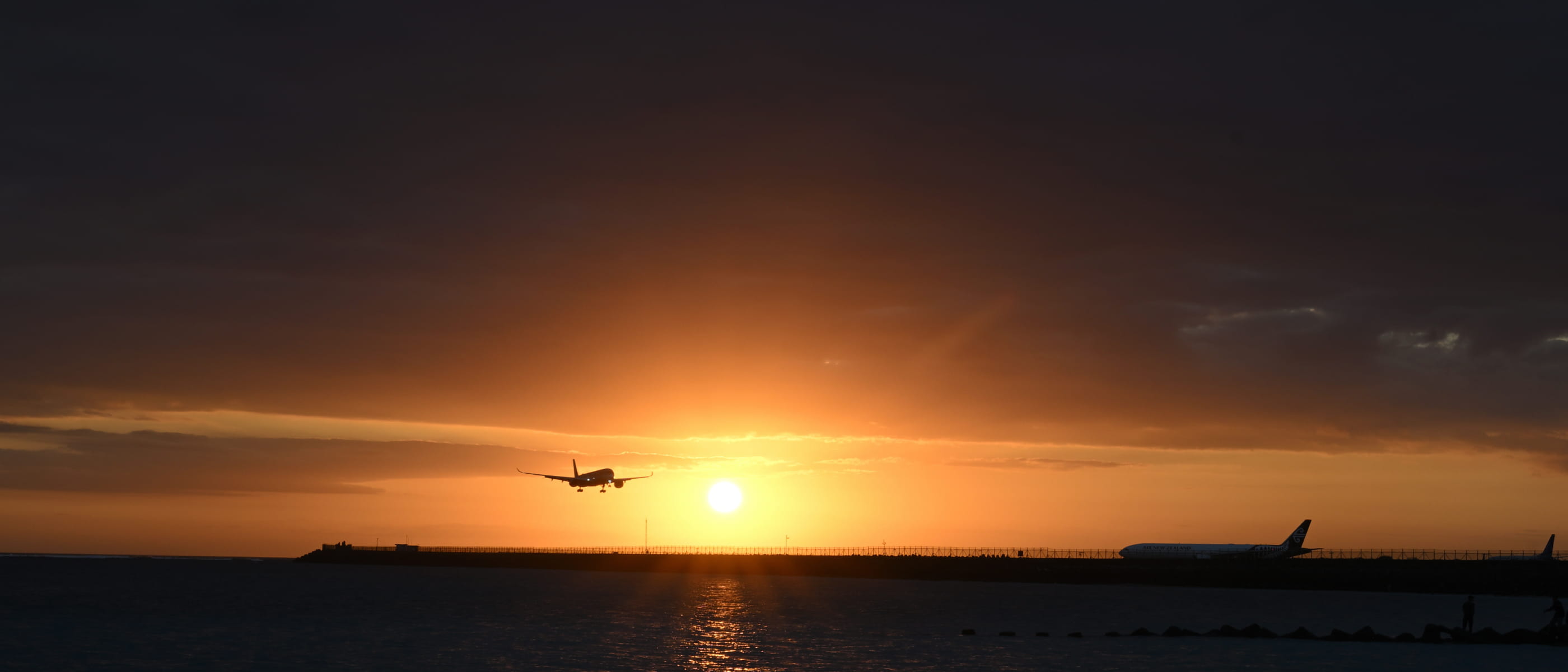 photo of a plane in a sky at sunset taken with the NIKKOR Z DX 16-50mm f/2.8 VR lens