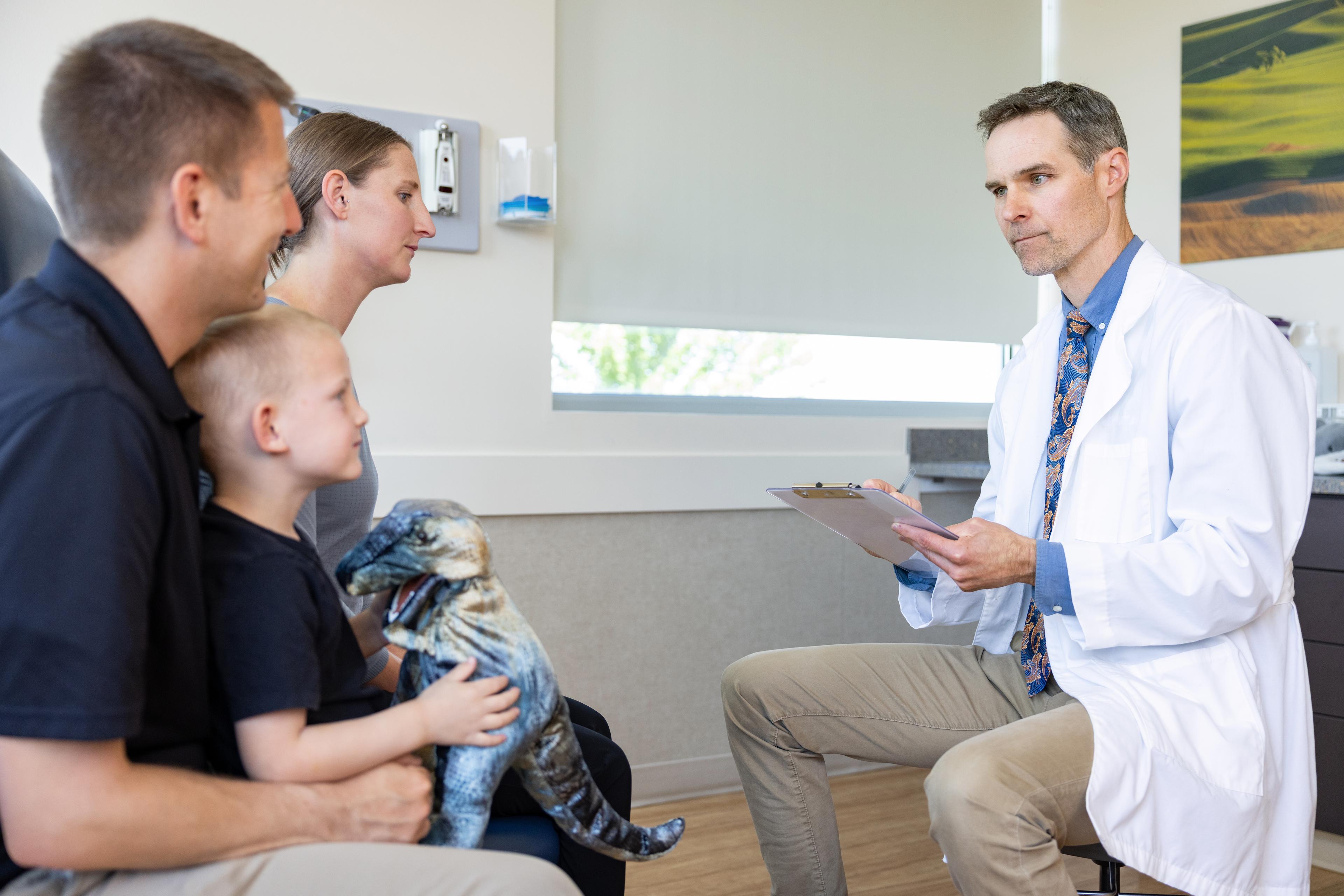 Healthcare professional discussing care with a parent and child.
