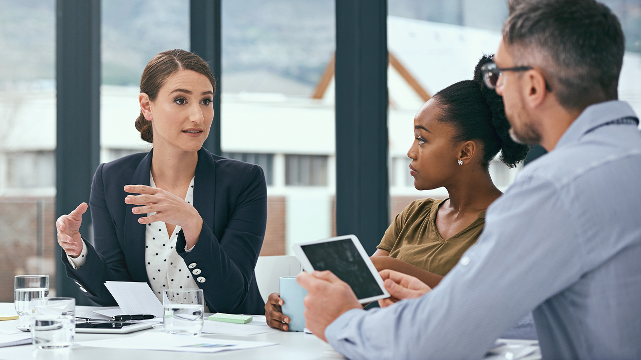 Coworkers in modern office at conference table