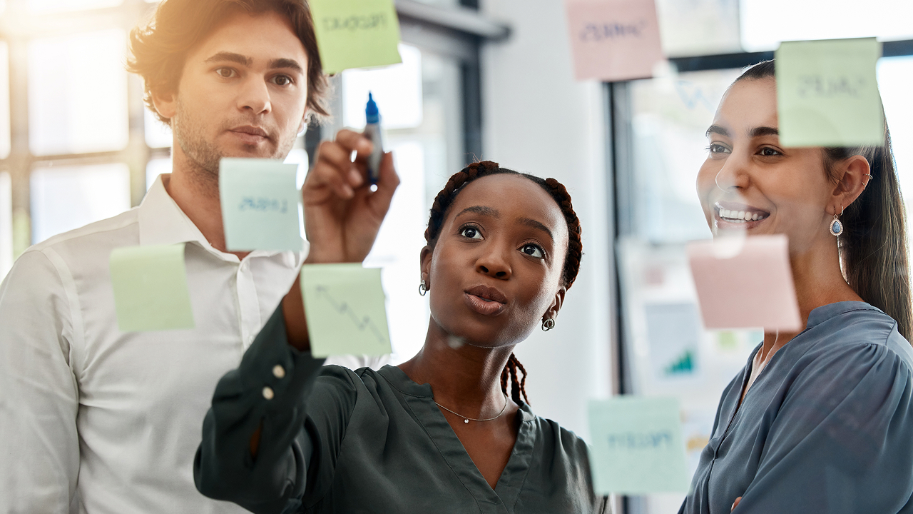 Group of students working at a whiteboard