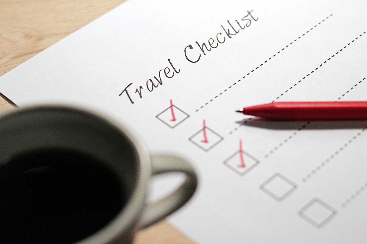 Printed_travel_checklist_with_gear_on_wooden_table_(1).jpg