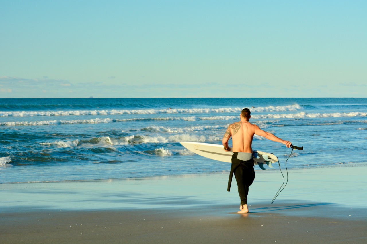 Surfers_in_the_water_at_Papamoa_Beach_Large.jpeg