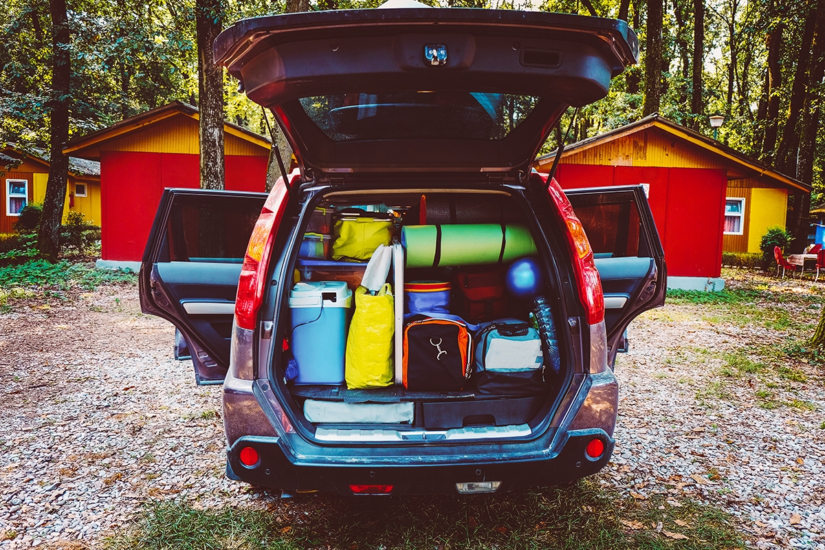 Packed car trunk with cooler, pillows, and hiking gear (1).jpg