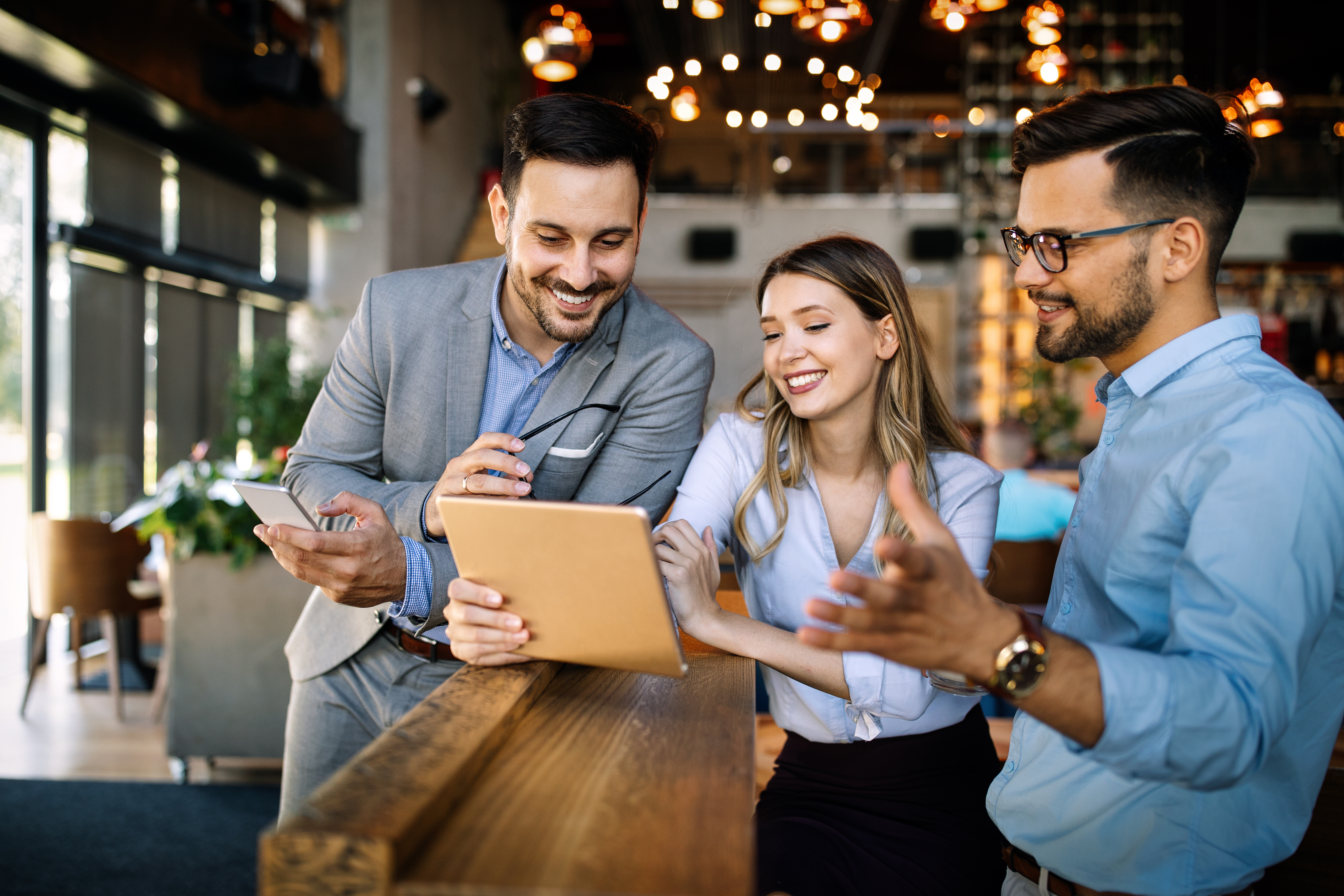 Image of employees looking at an ipad