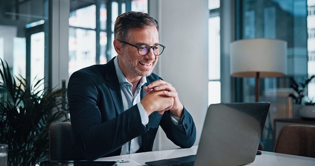 excited man at laptop