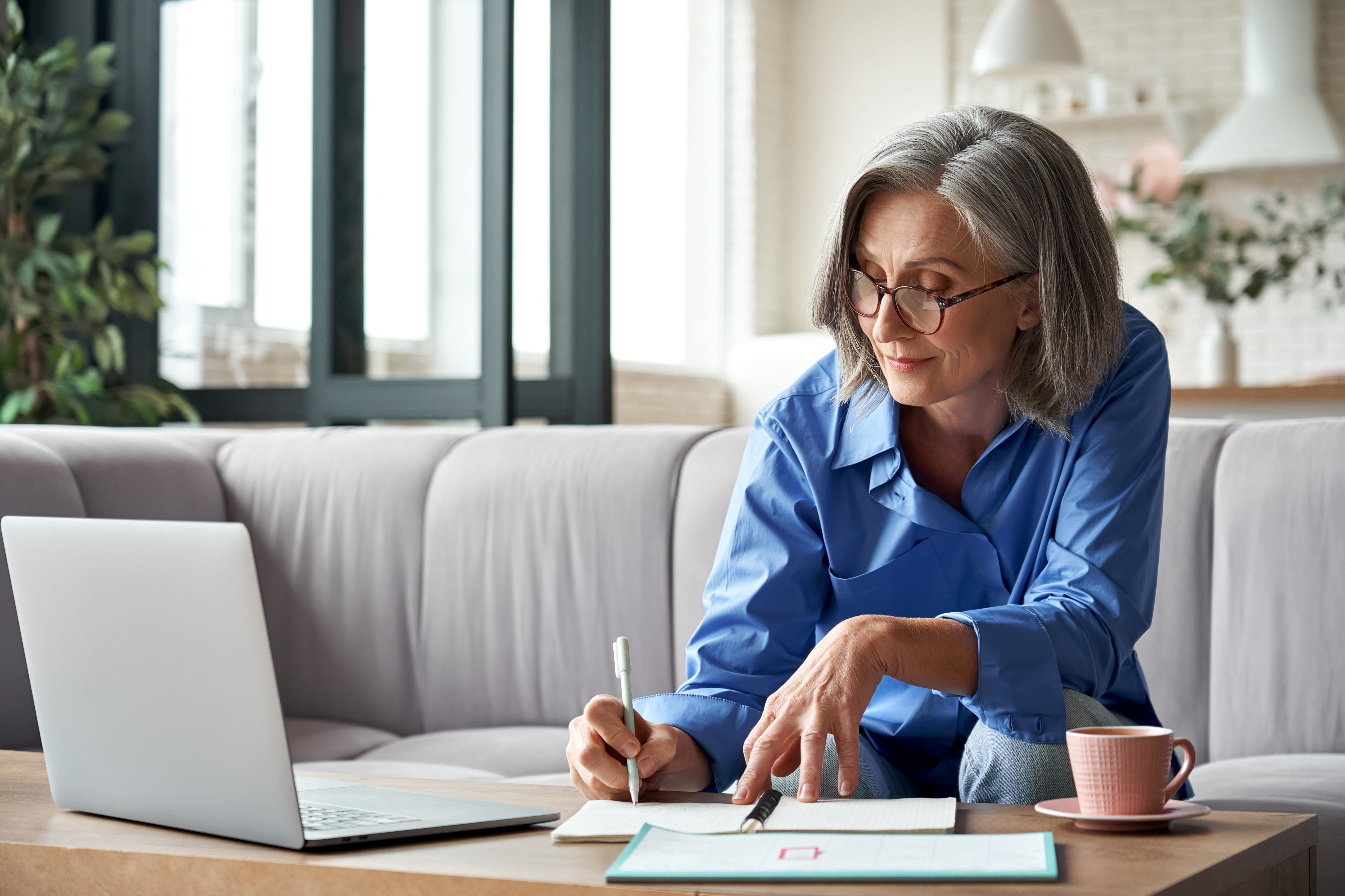 A woman writing notes on the table