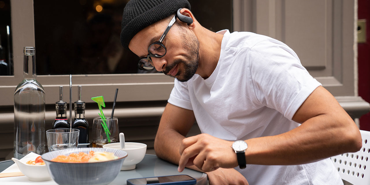 Man on mobile device learning about the debt avalanche strategy