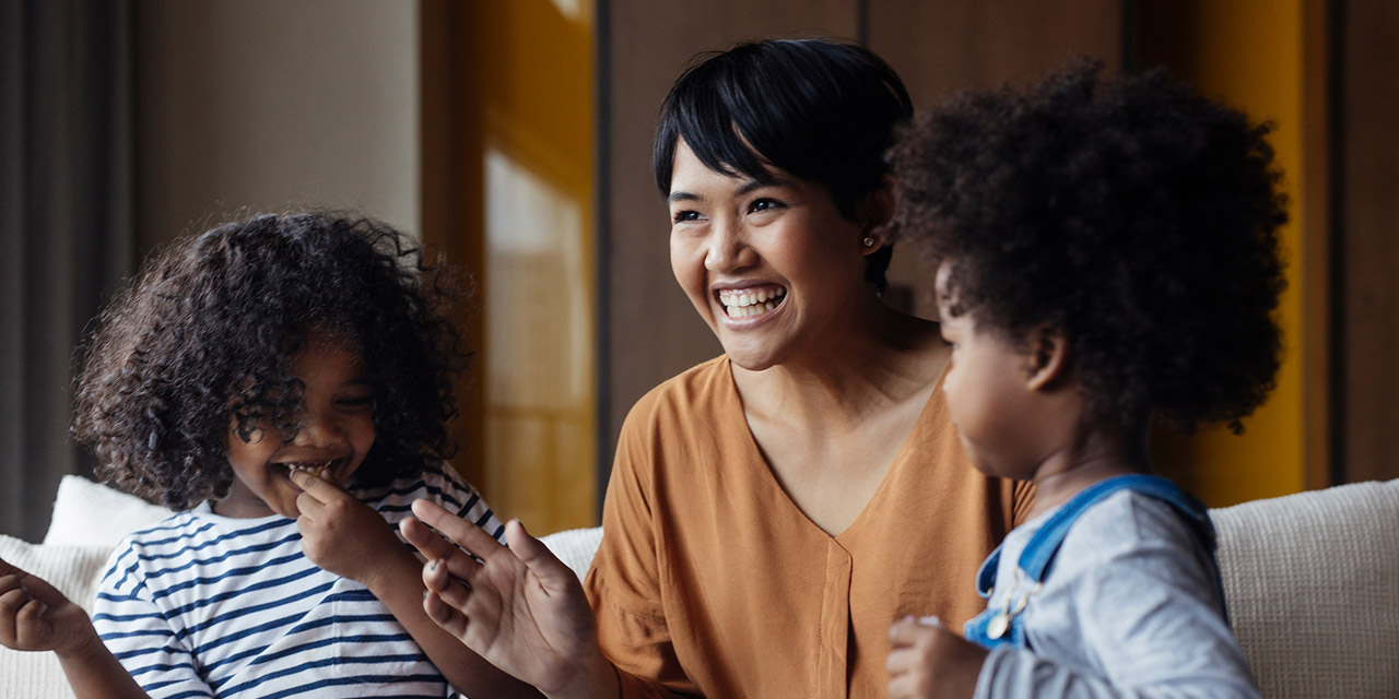 A woman with her two young children discussing the goal and purpose of savings.