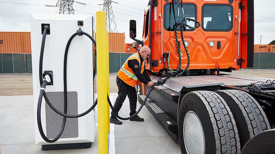 A Schneider driver plugging in his electric Intermodal truck at the charging depot at Schneider's South El Monte, CA location