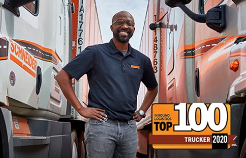 Schneider driver poses with trucks and trailers
