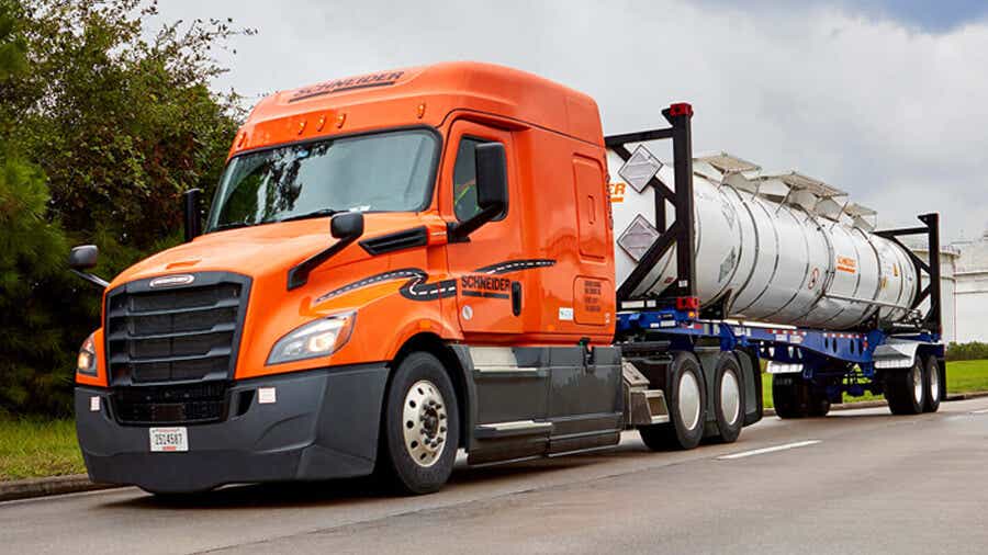 A Schneider tractor hauls a bulk intermodal express container.