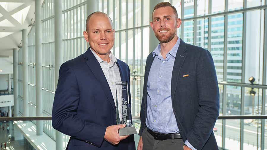 Schneider leaders, Jake VandeLoo and Jeremy Hock, hold the ACT Expo award for 2024 Top Fleet