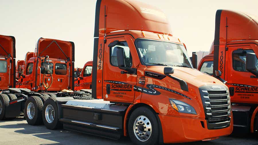 A group of Schneider's eCascadia fleet parked in the lot 