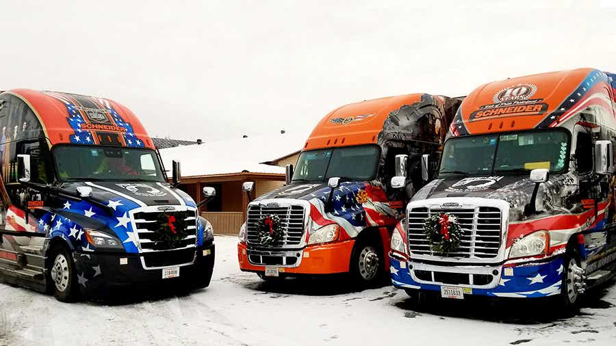 Schneider Ride of Pride trucks loaded with wreaths from Wreaths Across America