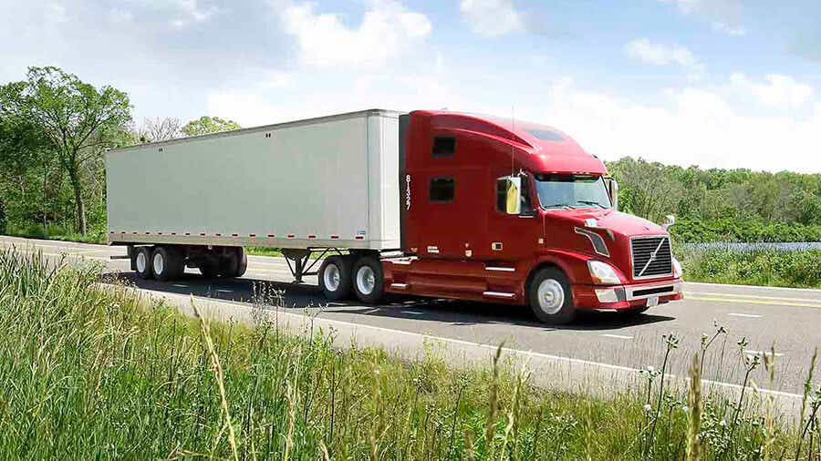 Semi truck and trailer on the road.