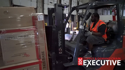 Forklift driver moving freight.