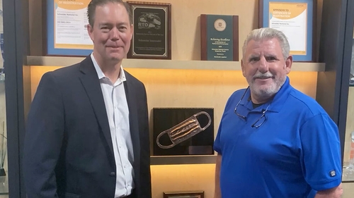 Schneider Senior Vice President and Chief Commercial Officer Jim Filter and SanMar Director of Global Logistics John Jansen.