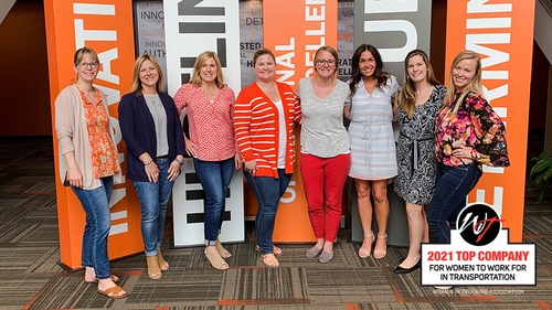 Schneider associates pose for a photo.