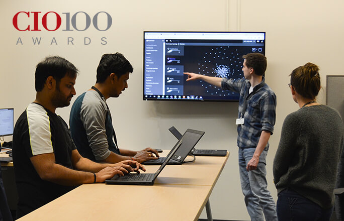 Image of Schneider associates assessing technology advancements and ongoing enhancements for carriers, shippers and Schneider associates.