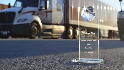 Smartway award with Schneider truck and trailer in the background.