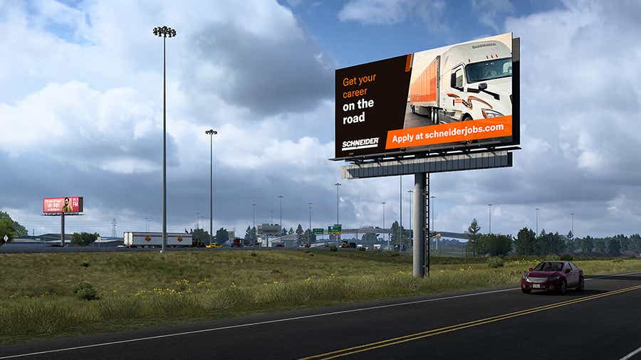 A screenshot taken from American Truck Simulator showing one of Schneider's in-game billboards that advertises truck driving jobs.