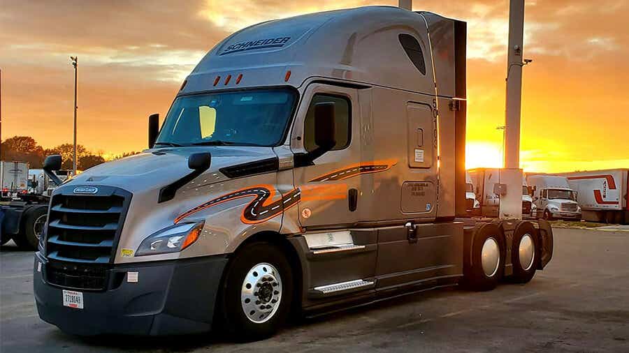 Schneider Van Truck parked with sun setting on the horizon.