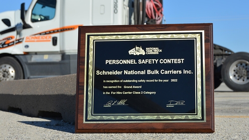 Schneider's Personnel Safety Contest award sitting in front of a Schneider bulk truck
