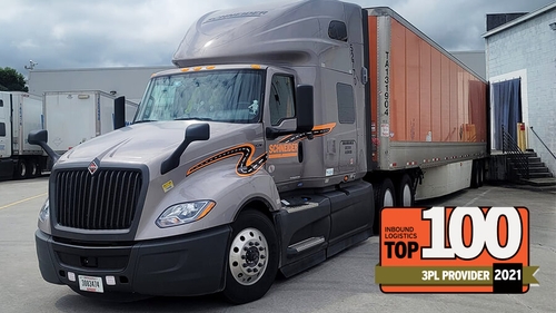 Schneider truck and trailer parked at location.