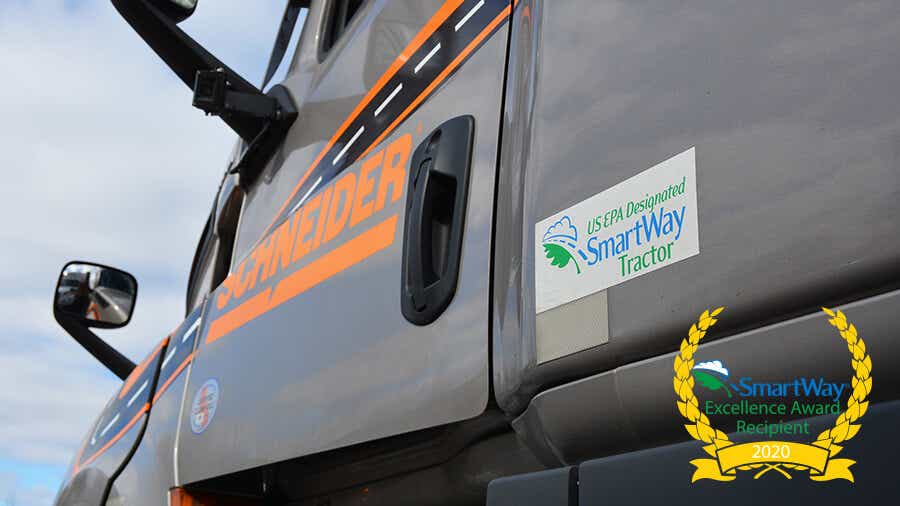 A decal with Schneider's SmartWay designation is proudly displayed on a company tractor