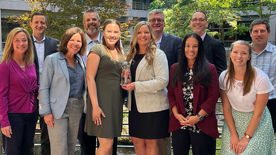 A group of Schneider associates hold the 2002 PepsiCo award for Sustainability Carrier of the Year.