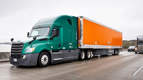Truck and Schneider trailer parked on the side of the road.