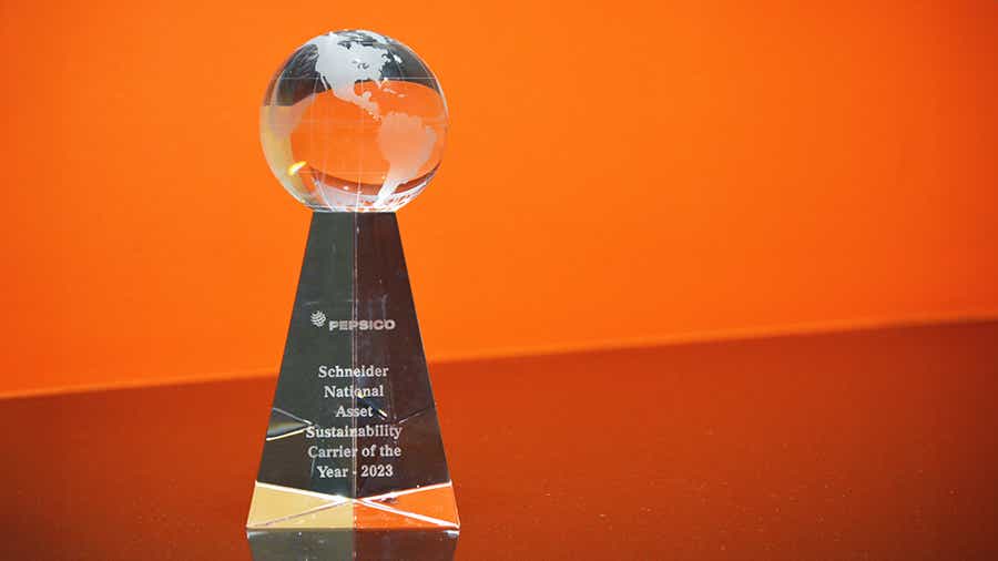 A transparent crystal trophy with a globe design at the top with PepsiCo logo 