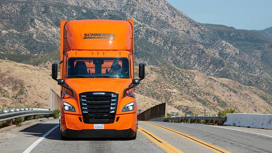 One of Schneider's eCascadia battery electric trucks drives down the highway in Southern California