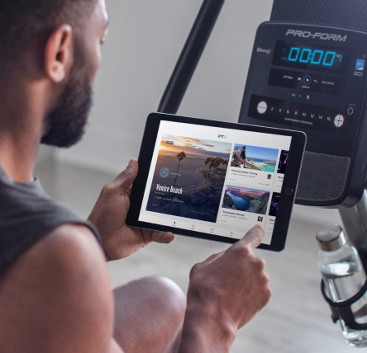 Man does an iFIT cycling workout on his bike
