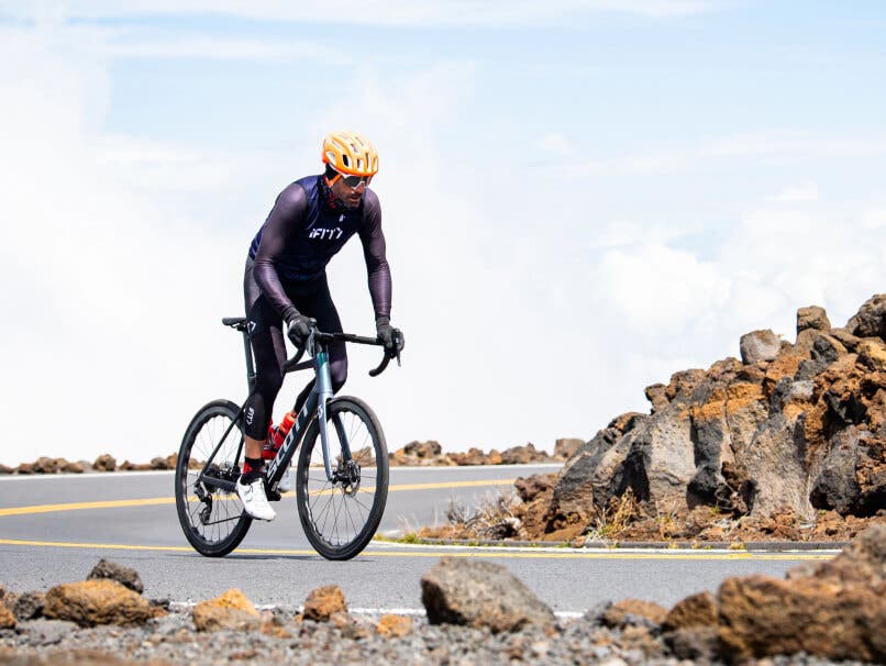 Man riding a bicycle a road bike outside