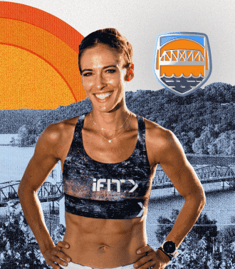 Woman smiling with a river and a bridge behind her