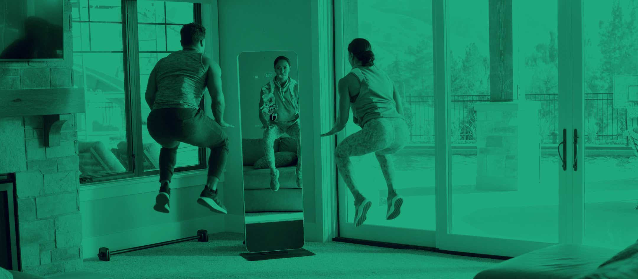 Man and woman exercising in-front of a fitness mirror
