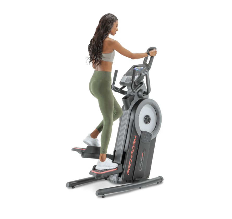 Woman using elliptical machine