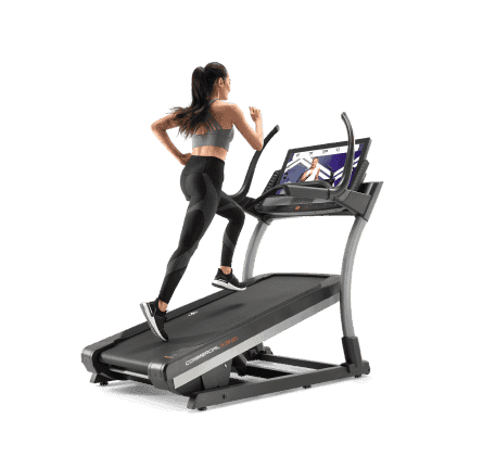 Woman does a running workout on an iFIT-enabled treadmill