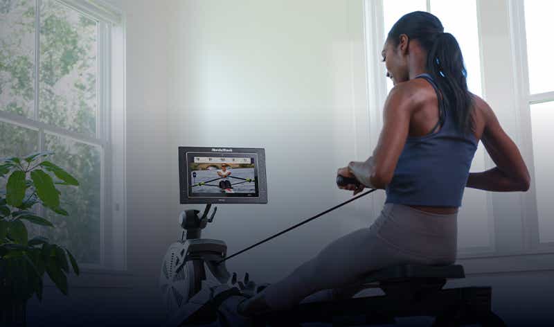 Woman using NordicTrack rower for iFIT class
