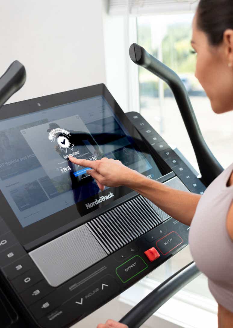 Woman uses screen on NordicTrack treadmill